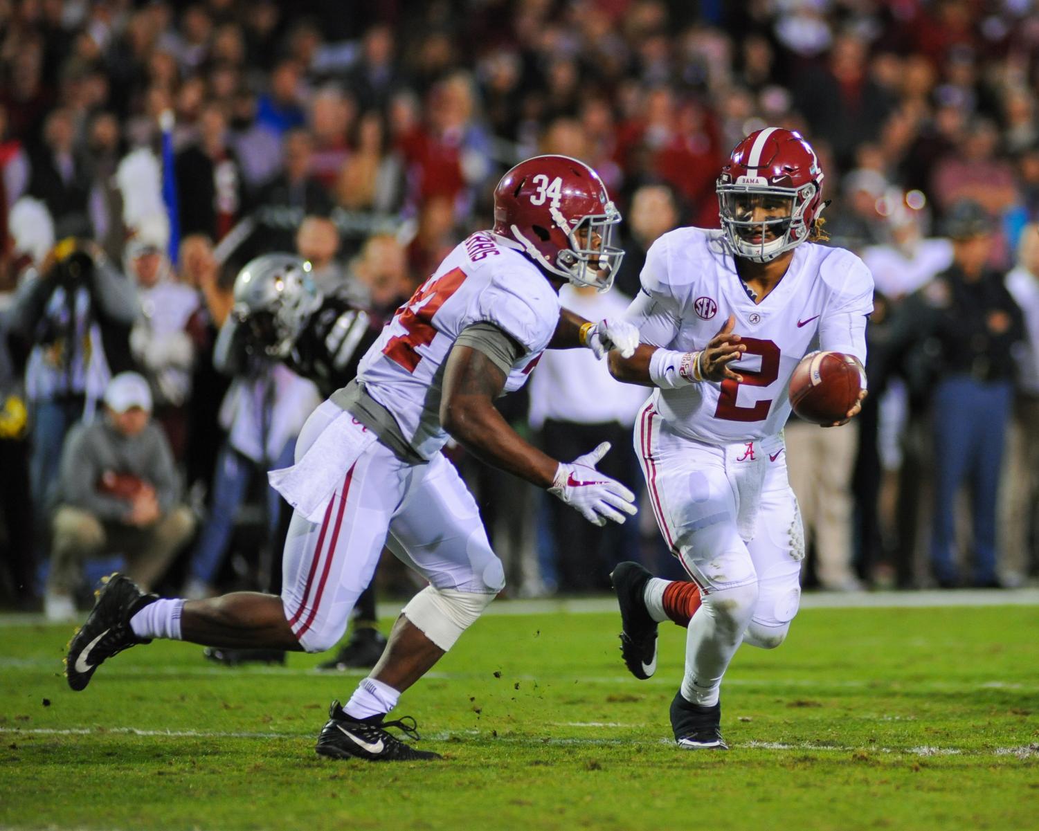 Alabama Crimson Tide quarterback Jalen Hurts (2) hands the ball off to running back Damien Harris (34) against Mississippi State.