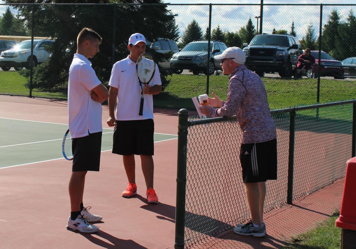 Coach+Stephen+Nellis+does+some+last+minute+coaching+to+help+senior+Zachary+Yurconis+and+junior+Jacob+Giardina+prepare+for+their+upcoming+match.+