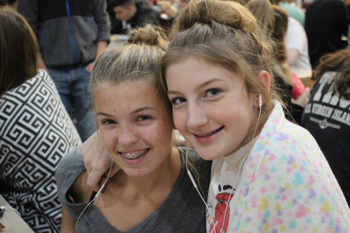 Sophomores Leah Glaspie and Elizabeth Wallner pose together at their lunch table on pajama day.